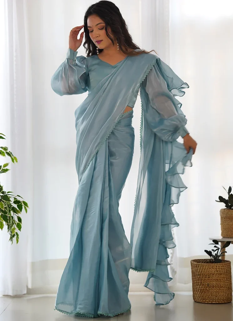 Stylish sari with ruffled pallu and layered pleats, offering a romantic, contemporary silhouette.