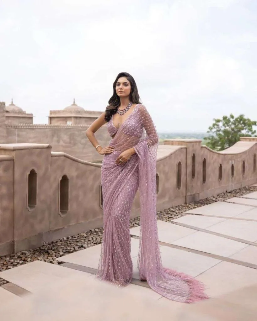 Glamorous sari with butterfly pallu drape exposing the midriff, ideal for red carpet or evening gala events.